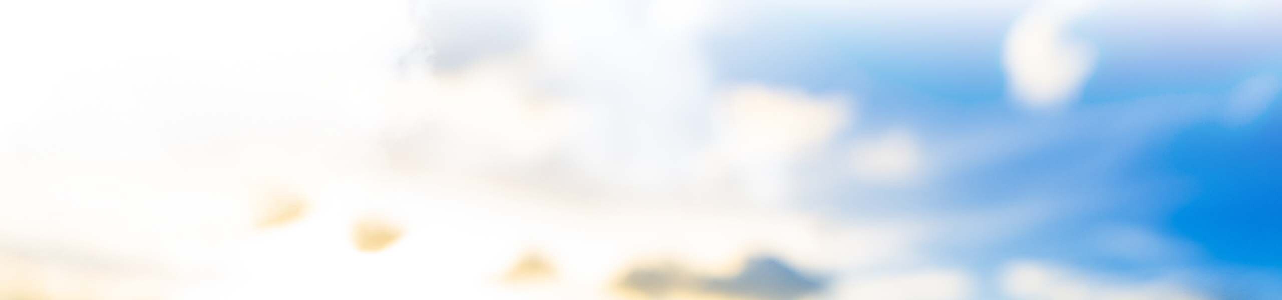 Blurred sunlit blue sky and clouds